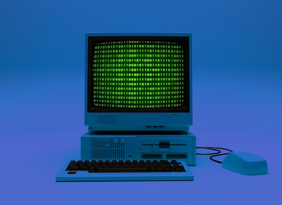 computer with coding on it, computer mouse, and keyboard in blue light